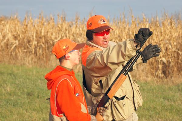 A youth receives gun safety training from a PF mentor