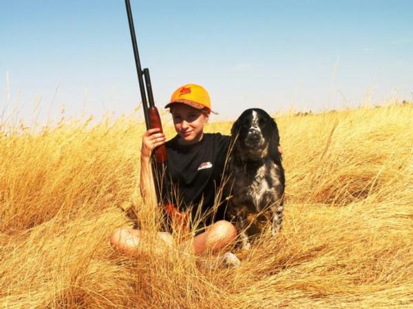 A young hunter poses with Dakota, an English Springer Spaniel during the Headwaters 2012 youth hunt